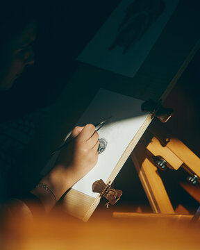 close up of woman painting in the sun