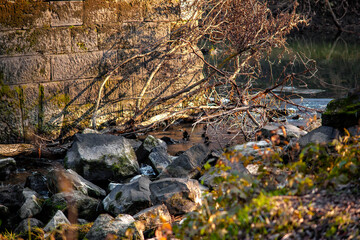 brick wall on a small waterfall. big stones on the wall