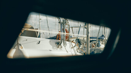 view through sailboat's hatch of neighbouring yacht in marina