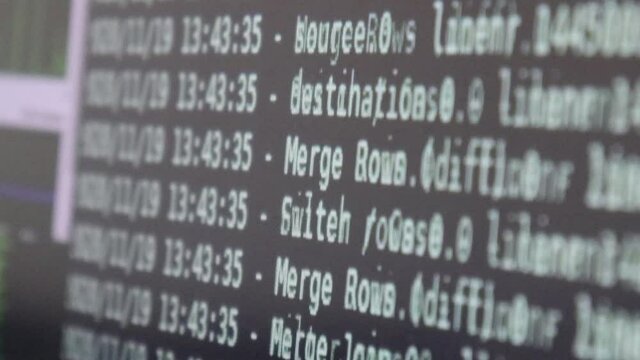 White computer software code moving on a black monitor reflect on glass defocused. Abstract computer hacking in process with rack server base, dynamic text running and flowing on pc screen