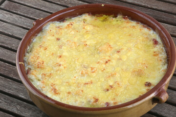 prepared meal bowl of potatoes and onion gratin as vegan food