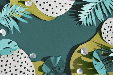 Tidewater green color background. Trendy flat lay, top view with decorative paper exotic leaves,...