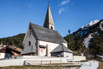 Fototapeta na wymiar Small church in the mountains. Natural sunlight, Dolomites. Italy.