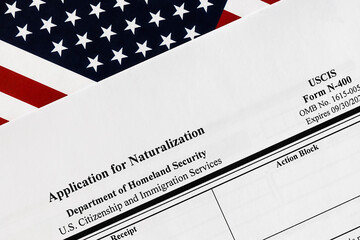 close-up of n-400 form. application for naturalization topview, on a background of United States flag.