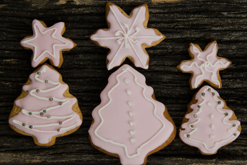 Christmas tree iced gingerbread cookies on a old textured wood background. Home made. Food backgrund.