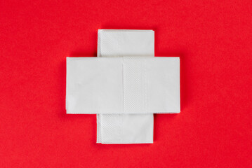Top view of facial tissues healthcare cross sign