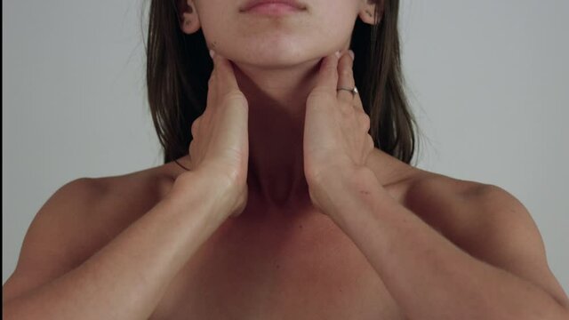 Woman rubbing neck - head on view - close up