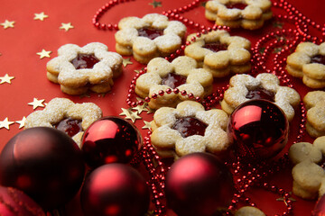 Christmas cookies and decorations on a red background.