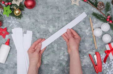 Christmas diy craft, making three-dimensional paper decor for decorating a room. Step-by-step instructions. Step 6 - take one strip of paper
