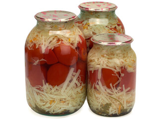 Canned and preserved tomatoes and cabbage in glass jar. Homemade pickled vegetables.