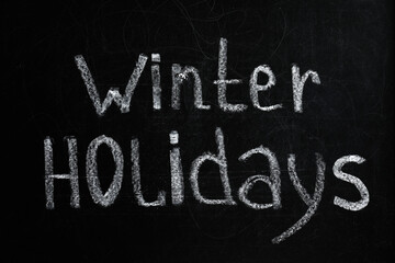 Phrase Winter Holidays written on black chalkboard