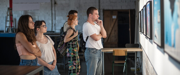 Group of friends in modern art exhibition gallery hall contemplating artwork. Abstract painting