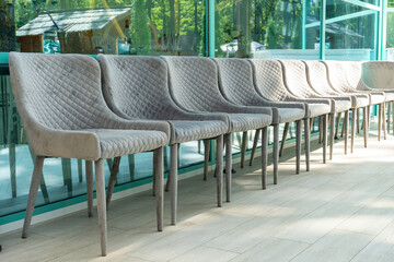 Gray chairs with a soft base stand in a row
