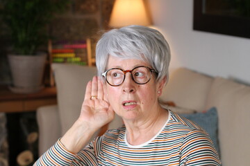 Curious grandmother gossiping at home
