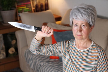 Senior woman holding knife at home