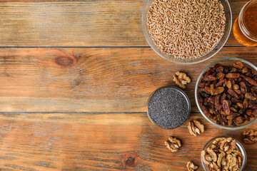 Ingredients for traditional kutia on wooden table, flat lay. Space for text