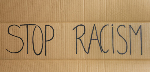 Poster with the text Stop Racism.Politics and social problems concept, anti racial discrimination background.