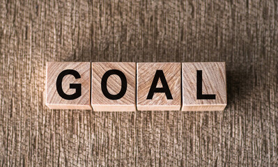 Fototapeta premium GOAL. Word written on wooden blocks over brown background.