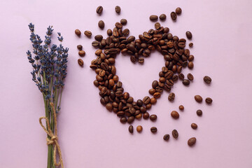 Lavender bouquet with a heart made of coffee beans on a purple background, top view, close-up, space for text-the concept of pleasant holidays