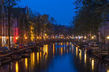 Fototapeta premium Amsterdam. Night view of Amsterdam cityscape with canal, bridge and typical Dutch Houses. Netherlands.