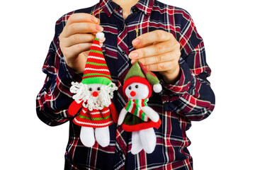 Isolated photo of a young girl in shirt holding decorative christmas figurine toys on white background.