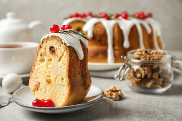 Composition with piece of traditional homemade Christmas cake on light grey table, closeup