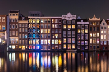 Amsterdam. Night view of Amsterdam cityscape with canal, bridge and typical Dutch Houses. Netherlands.