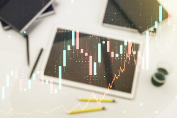 Multi exposure of abstract financial diagram and modern digital tablet on background, banking and accounting concept