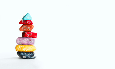Obraz premium Abstract Colorful Background. Candy Rocks Balancing. Colorful Stones Over White Background. Stack Of Balanced Rocks. Stones Balanced On Top Of Each Other.