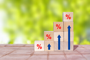 Arranging wood block stacking as step stair with sign percent and arrow up symbol. Interest rate financial and mortgage rates concept