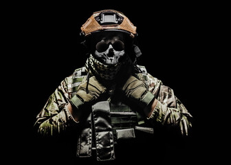 Photo of a fully equipped skeleton zombie soldier standing in armored vest on black background.
