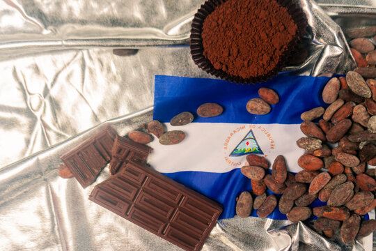 Nicaraguan premium chocolate concept. Cocoa beans, powder and chocolate bar on a silver background. - Powered by Adobe