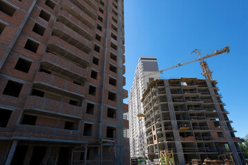 Tower crane. Construction site. Production of apartments, social housing.