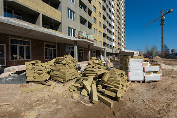 External insulation for the walls of the house. Construction site. Production of apartments, social...