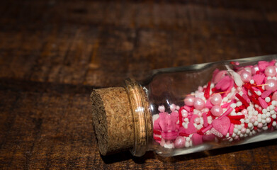 White, pink, red hearts, sticks, balls on a wooden background.pastry powder. valentine's day. High quality photo