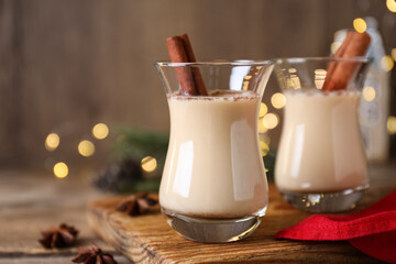 Delicious Christmas liqueur on wooden board, closeup