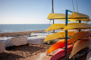 Sheathed catamarans and boats on the seashore. End of the swimming season. Winter.