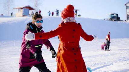 Happy coulple dating in mountain ski resort at sunny day. Winter, sport, holidays, relationship, love, xmas, lifestyle concept. Filmed on cinema camera, 10 bit color space.