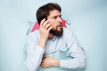 emotional man in blue shirt breaks through wall emotions cropped view office