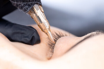Contouring woman eye permanent make up tattoo black in beauty salon - obrazy, fototapety, plakaty