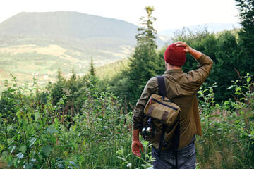 Man enjoy scenics view on valley. Hiking journey on tourist trail. Outdoor adventure. Beautiful nature landscape in mountains. Travel and exploration. Healthy lifestyle, leisure activities