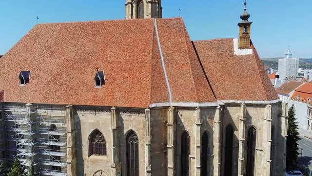 Cluj-Napoca,Cluj/Romania-07.20.2019-Sfantul Mihail Church,located in the center of the city,in Matei Corvin Square (Mathias Rex).Aerial 4k footage near the tower clock