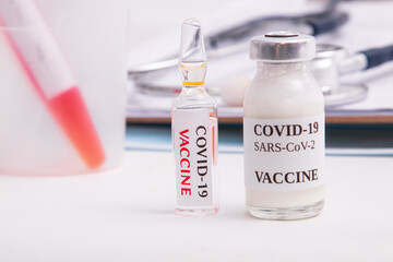 coronavirus vaccine vial in healthcare medical background