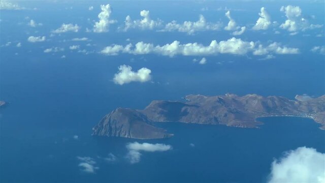 Flying over the Greek Islands.
Airliner flies over the Greek Island of Tilos, Aegean Sea.
