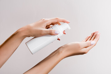 cropped view of woman applying cleansing foam isolated on grey, stock image