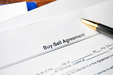 Legal document Buy-Sell Agreement on paper with pen