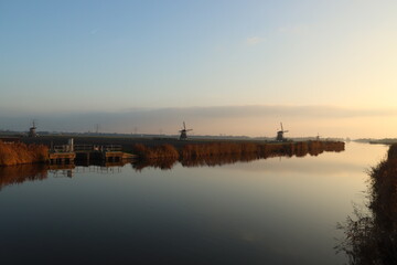 Fototapeta premium Sunset over the river Rotte in Zevenhuizen with windmills of the Molenviergang