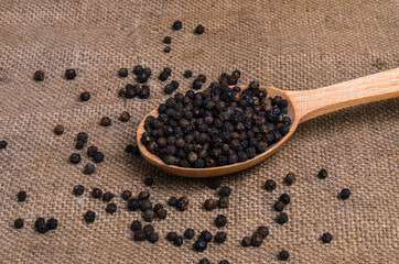 black pepper in a wooden spoon