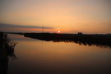 Sunset over the river Rotte in Zevenhuizen with windmills of the Molenviergang