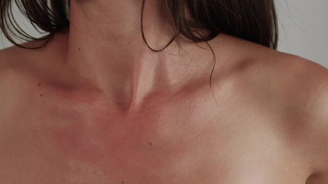 Woman's collar bone close up on isolated white background